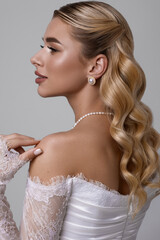 Elegant Bride Portrait Featuring a Beautiful White Dress, Soft Waves, and Exquisite Jewelry