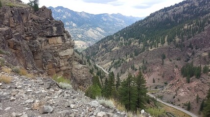 Mountain valley vista with rocky cliffs and road