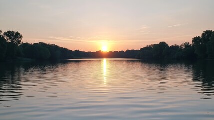 Naklejka premium Tranquil sunset over a lake, silhouettes of trees