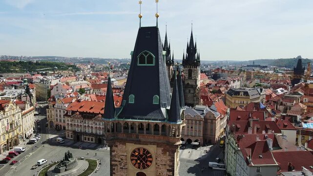 Drone medieval Prague square with famous clock tower and twin-spired church