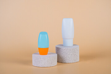 Cosmetic product in tube, bottle, lotion or serum with stylish props on cream background. 