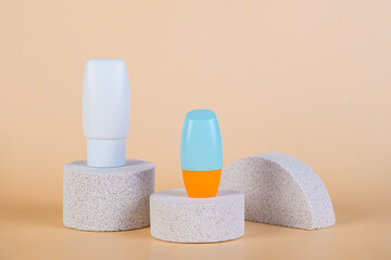 Cosmetic product in tube, bottle, lotion or serum with stylish props on cream background. 