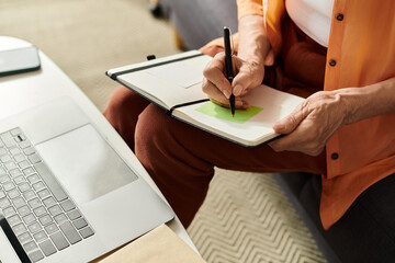 Senior woman enjoys a cozy moment at home while sketching ideas in her notebook