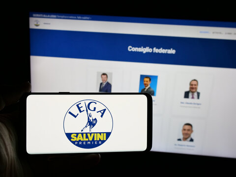 Stuttgart, Germany - 07-17-2025: Person holding smartphone with logo of Italian party Lega per Salvini Premier (LSP) on screen in front of website. Focus on phone display.