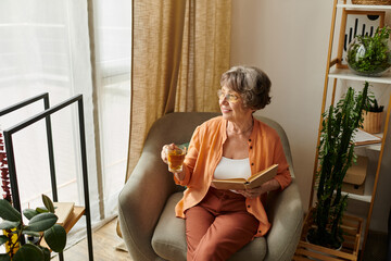 Senior woman enjoying a cozy afternoon with a book and drink in her comfortable home setting