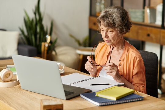 Senior woman enjoying a productive afternoon at home with cozy attire and warm ambiance