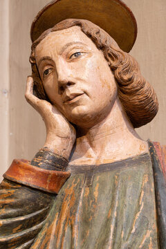 PIACENZA, ITALY - MAY 20, 2025: The detail of terracota statue of St. John the Eevangelist under the cross in the church Basilica di San Antonio by unknown artist (cca 1470).