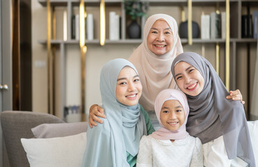 Four generations of muslim woman in hijab enjoying family time showing love, joy and happiness,...