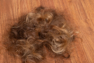 Cut Hair on Wooden Floor After Shaving Head,Symbol of Change and Healing