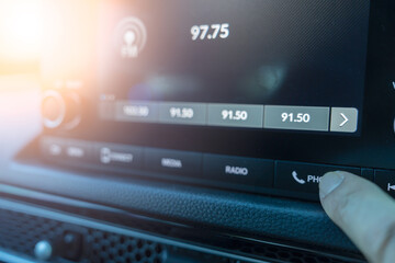 Finger of man is pressing the answer button on a car phone. Bluetooth connection button in car,...
