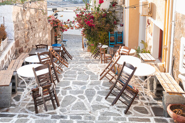 Cozy Alley with Tables and Bougainvillea in Plaka, Milos