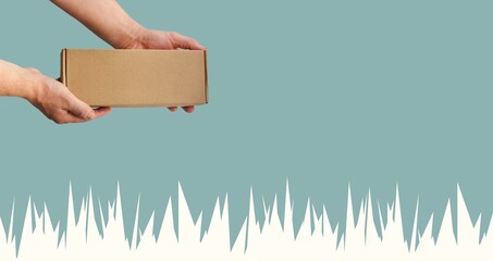 Paper box in hands. Holiday shopping. Closed cardboard package. Cut out. Icicles on blue background. Winter season parcels. Place for text. Sustainability and modernity