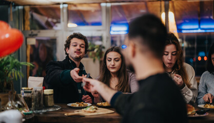 Friends engaging in friendly interaction while dining together at a vibrant bar setting.