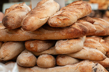 Freshly baked,  crisp and crunchy baguette loaves on sale in a bakery.
