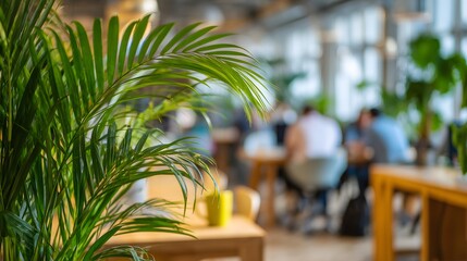 Fototapeta premium Indoor plant office setting, Blurred people working background, Green office environment, Biophilic design workspace