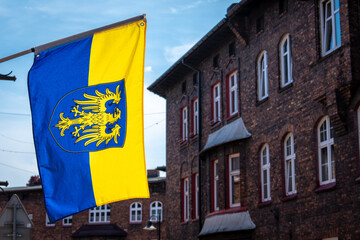 Silesian Flag Waving with Nikiszowiec District Building Background