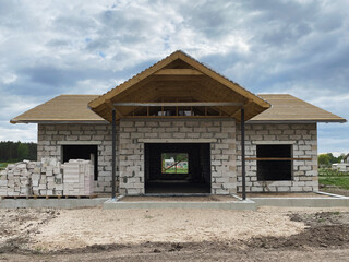 Unfinished Single-Family House Under Construction with ACC Blocks Walls and Wooden Roof Frame
