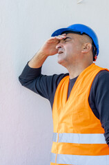 Tired and exhausted mechanical technician or building contractor. Bad news triggering headache