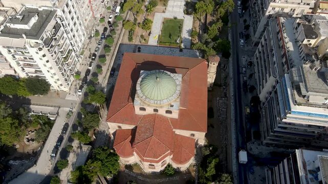 Aerial view of the Hagia Sophia Church with its dome and red-tiled roof amid the city's buildings and streets, Thessaloniki, Thessaloniki, Greece.