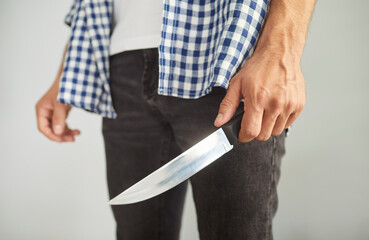 Criminal man holding knife to attack and kill, to hurt victim of domestic violence. Aggression and...