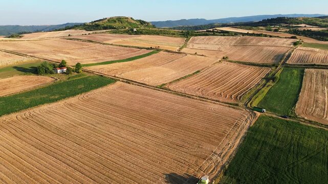 Hay mower tractor tedder modern agriculture field work rural village, aerial drone