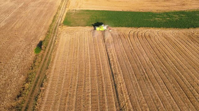 Agriculture hay mower tedder tractor modern field work rural village, aerial drone