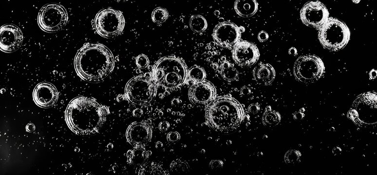 Abstract rings in black liquid - Powered by Adobe