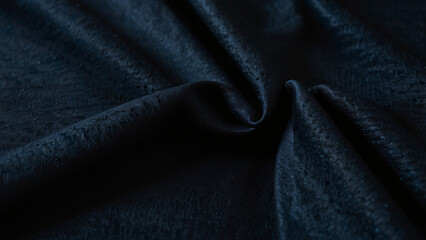 Deep blue textured fabric with dramatic folds