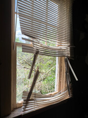 old broken venetian window blinds of an abandoned building