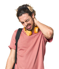 Young student with backpack and headphones suffering neck pain due to sedentary lifestyle.