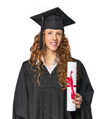Proud redhead graduate with diploma, studio shot