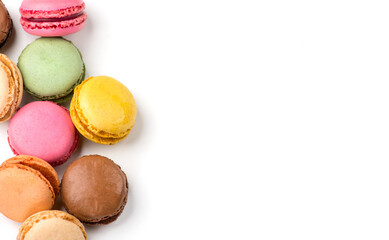 Macarons, macaroons, colorful assortment border design, vibrant pink, yellow, green, brown French pastries creamy fillings, macaroon isolated on white background, flat lay, top view design 