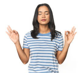 Young Latina posing in studio relaxes after hard working day, she is performing yoga.