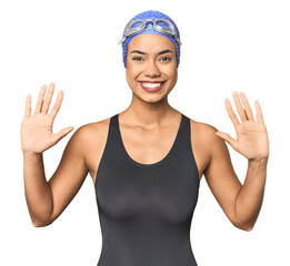 Pro Latina swimmer in studio gear showing number ten with hands.