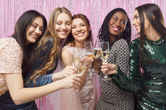 Happy funny beautiful multiracial friends girls, bride drinking champagne, women have hen party at club, diverse female laughing to celebrate bachelorette bridal shower entertainment wedding gathering