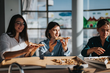 A group of colleagues sharing a pizza during a relaxed lunch break in a bright and modern office...