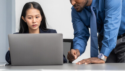 Diverse tech team meeting on software project, mentor guiding coworker on laptop, teamwork development using collaboration tools, modern technology, app design, dev training and enterprise SaaS team