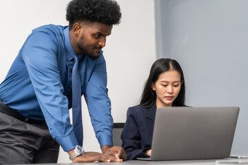 Diverse tech team meeting on software project, mentor guiding coworker on laptop, teamwork development using collaboration tools, modern technology, app design, dev training and enterprise SaaS team