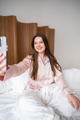 Woman in pajamas taking selfie
