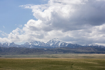 Spring steppe in Kazakhstan with snowy mountains