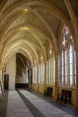 Upper cloister of Burgos Cathedral with pointed vaults and stained glass