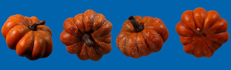 Vibrantly colored pumpkins sit against a blue backdrop, showcasing their unique shapes and...