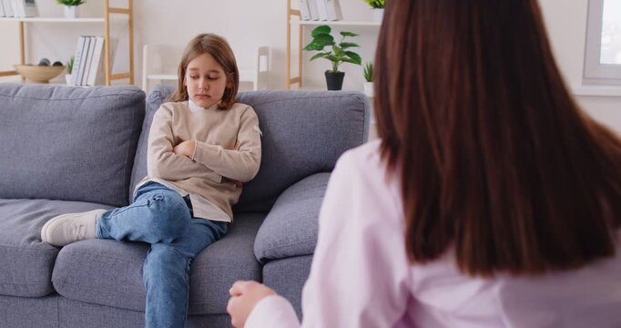 Angry mother shouting at her child for doing something wrong, having disagreement with teenager son, arguing and quarreling while being at home. Family, relationship, conflict concept