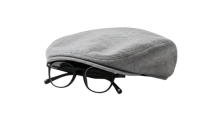 Gray newsboy cap and black eyeglasses on a black background.