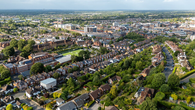 Aerial view of red-brick buildings nestled among lush greenery, creating a vibrant tapestry of urban and natural elements, Guildford, England, United Kingdom.