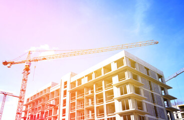 Tower crane on apartment Construction. Block House building construction. Apartments construction. Housing renovation, real estate. Crane on formwork in Built environment. Cranes on pouring concrete.