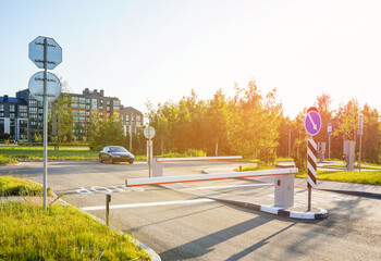 Automatic car barrier in Private urbanization residential area. Car barrier in front yard in Condominium. Barrier Gate on parking lot. Barrier for entry and exit to parking lot for residents of area.