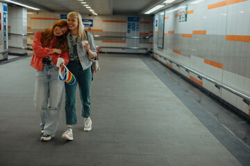 Friends walking and laughing in subway station