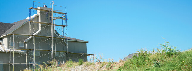 Panorama view chimney-focused construction site in Dallas, Texas with pitched roof installed....
