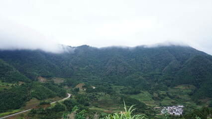 The beautiful mountains landscapes with the green forest and little village as background in the countryside of the China